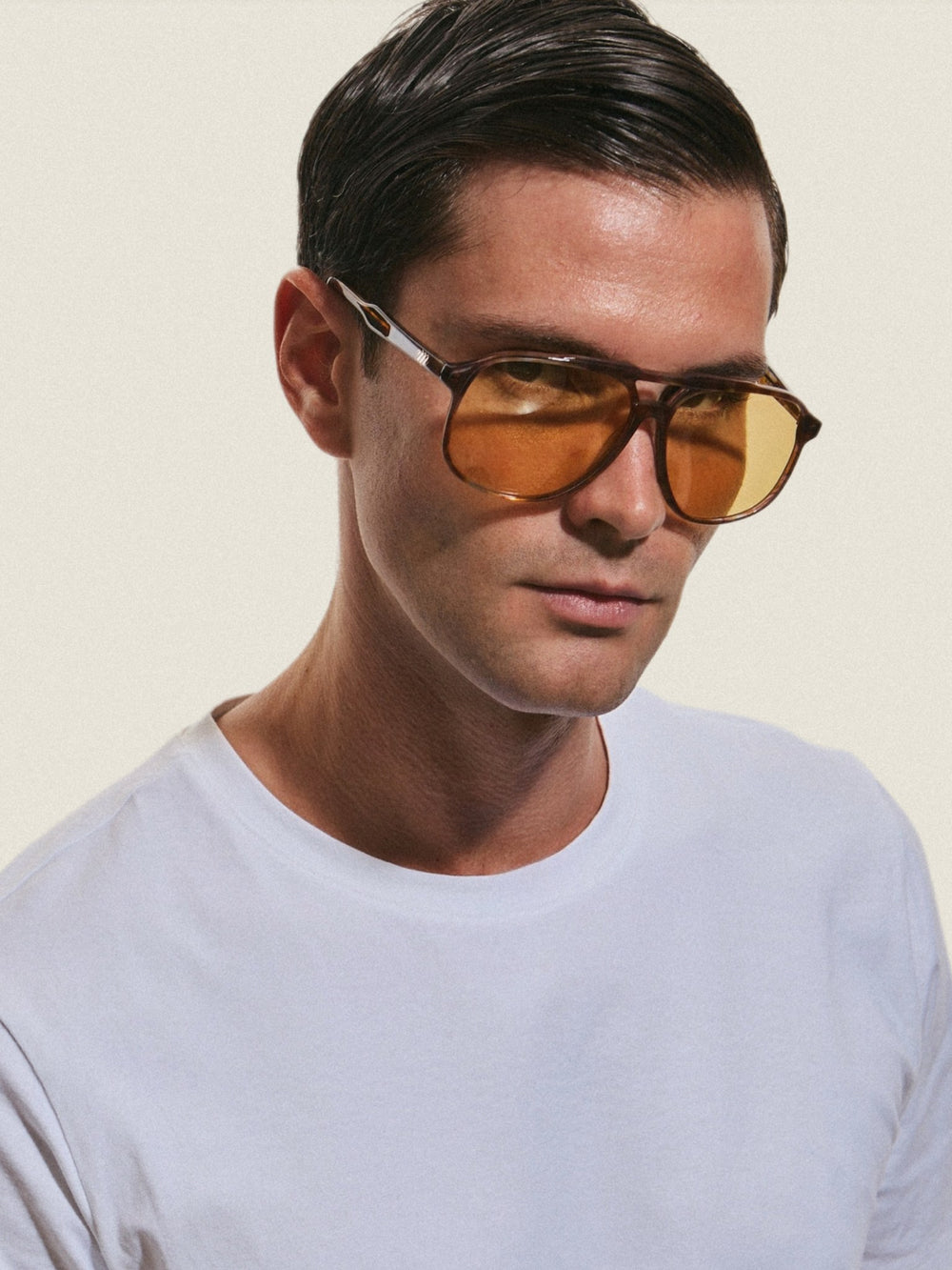 Model wearing Mawj aviator sunglasses in amber tortoise